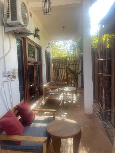 a living room with a couch and a table at Zanzibar beach escape 1&2 in Bwejuu