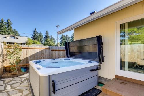 a hot tub sitting outside of a house at Walk to Dtwn Camas! Updated Home with Game Room in Camas