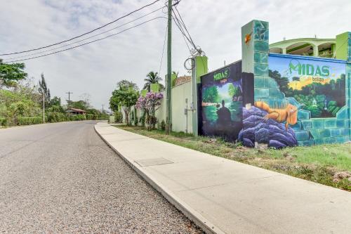 a street with a mural on the side of a building at La Casita at Midas Belize in Trapiche