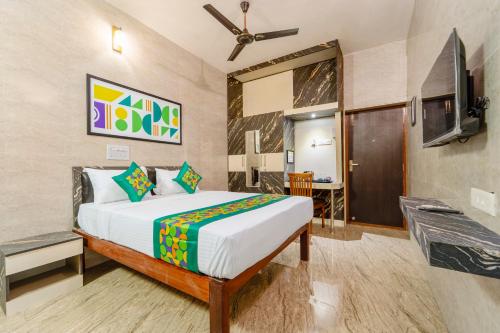 a hotel room with a bed and a tv at Treebo Dunag in Coimbatore