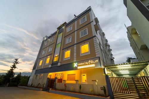 a building with a sign on the side of it at Treebo Dunag in Coimbatore