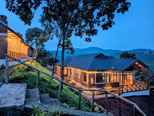 a house on a hill with a metal roof at Mvuli Mountain Lodge Ngorongoro in Karatu