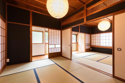 an empty room with windows and mats on the floor at 一棟貸し 小海の宿 いおり in Numazu