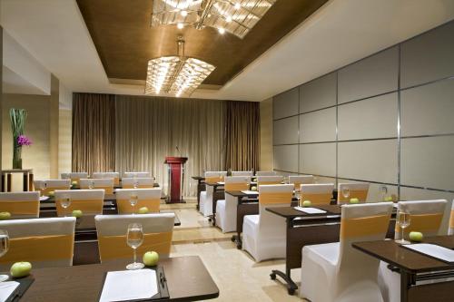 a dining room with tables and chairs at Swissotel Foshan, Guangdong - Free shuttle to Canton Fair in Foshan
