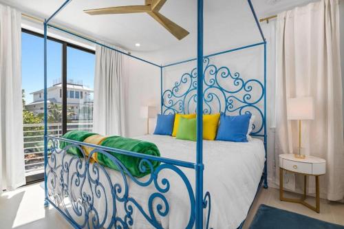 a bedroom with a blue and white canopy bed at Anna Maria Wave in Ilexhurst