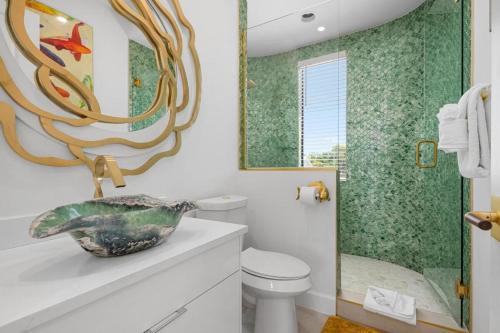 a bathroom with a sink and a toilet and a mirror at Anna Maria Wave in Ilexhurst