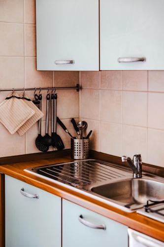 a kitchen with a sink and a stove top at Appartamento in centro storico La Corte in Domodossola