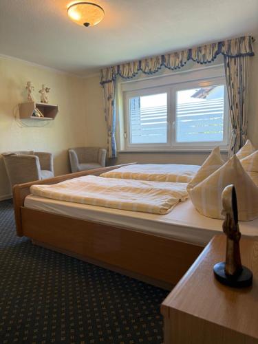 a bedroom with a large bed with a window at Haus Sonnenschein in Winterberg