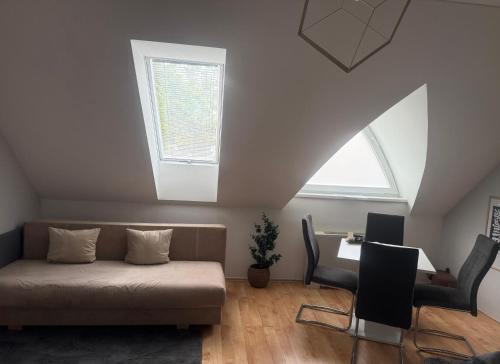 a living room with a couch and a window at Grace Apartman in Hajdúszoboszló