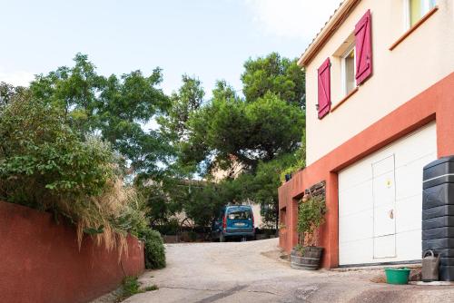 a blue truck is parked next to a building at Gîte Les Mathouans in Latour-de-France
