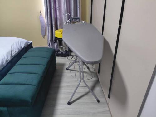 a room with a bed and a table and a couch at Mirembe residents in Kampala