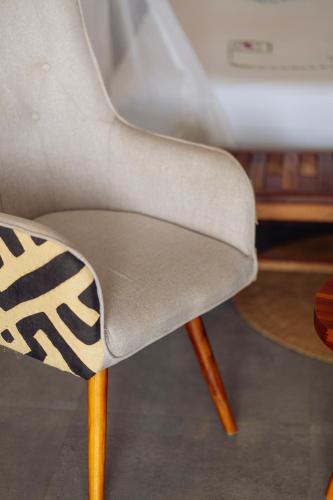 a white chair with a black and white design on it at Savera Beach Houses in Jambiani