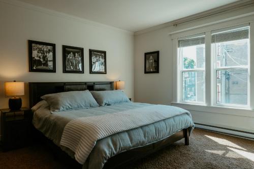 a bedroom with a bed and a large window at Modern Townhouse in the Heart of Downtown in St. John's