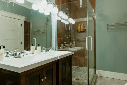 a bathroom with two sinks and a glass shower at Modern Townhouse in the Heart of Downtown in St. John's
