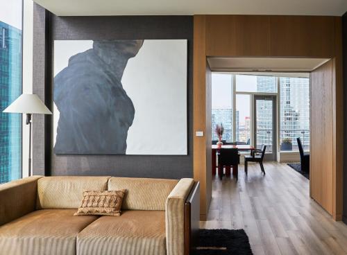 a living room with a couch and a large painting at Lux Apts with Lake Views and Top Amenities in Chicago