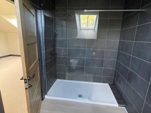 a bathroom with a shower with a bath tub at 1 New Dairy Barn in Sunderland Bridge