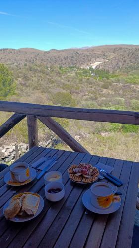 a picnic table with plates of food on it at Piedras Blancas in La Bajada