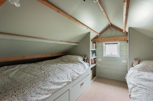 a bedroom with two beds and a window at Boshuisje Luna | 4 personen - Vakantiepark De Kremmer in Gasselte
