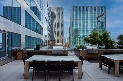 a balcony with tables and chairs and buildings at Lux Apts with Lake Views and Top Amenities in Chicago