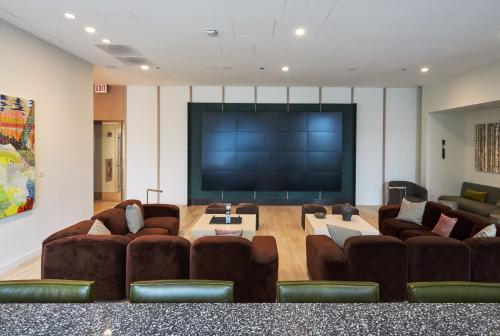 a living room with couches and a large screen television at Lux Apts with Lake Views and Top Amenities in Chicago