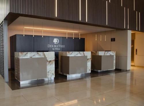 a lobby with marble counters in a building at Hilton DoubleTree Bogotá Salitre AR in Bogotá
