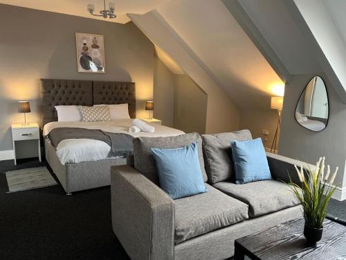 a living room with a bed and a couch at Alexander Hotel in Whitley Bay