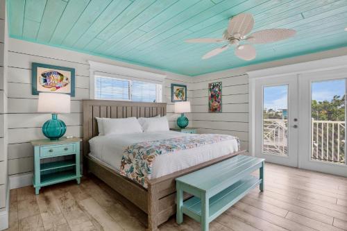 a bedroom with a bed and a ceiling fan at Salty Margarita in Anna Maria Island