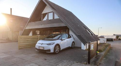 a small white car parked in front of a house at Townhouse Hirtshals with sea view in Hirtshals