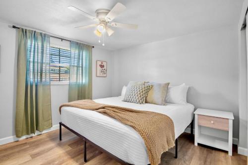 a bedroom with a bed and a ceiling fan at Gulf Haven East in Anna Maria Island