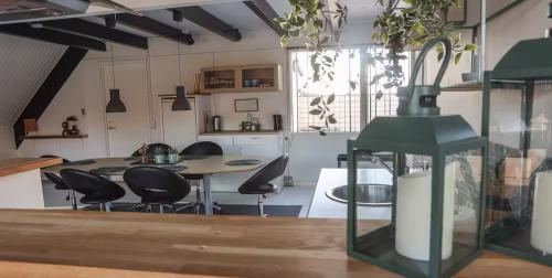 a kitchen and dining room with a table and chairs at Townhouse Hirtshals with sea view in Hirtshals