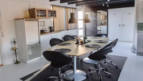 a kitchen with a table and chairs in a room at Townhouse Hirtshals with sea view in Hirtshals