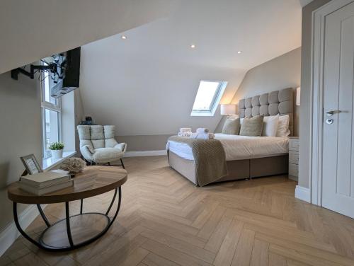 a bedroom with a large bed and a table at Mountain View Rooms in Newcastle