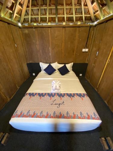 a bed in a room with a surfboard on it at Langit Wanagiri in Gitgit