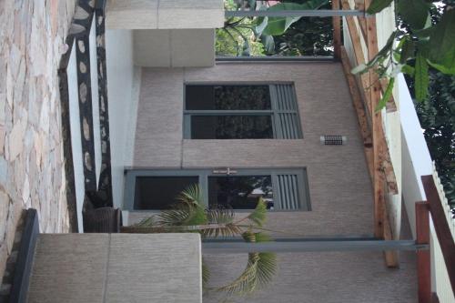 a building with palm trees in front of it at Serene villas in Kitala