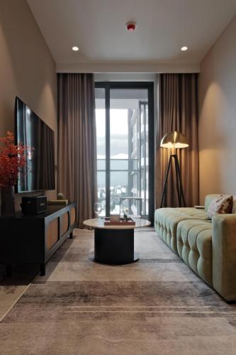 a hotel room with a bed and a large window at Lancaster Legacy Executive Apartments in Ho Chi Minh City