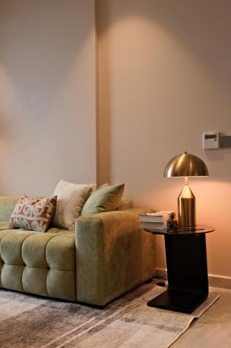 a living room with a couch and a table at Lancaster Legacy Executive Apartments in Ho Chi Minh City