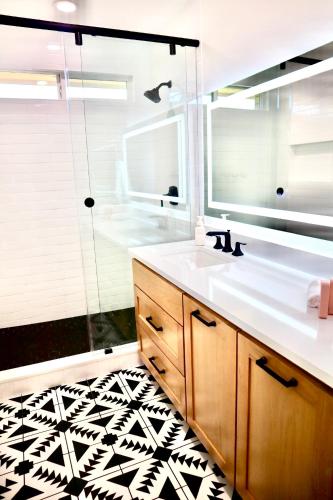 a bathroom with a sink and a mirror at Lovely 3BR with King Bed,15 Min from Downtown Austin in Austin
