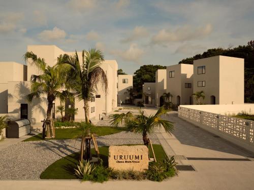 a rendering of a building with palm trees in front at URUUMI Onna Pool Villa ｳﾙｳﾐ ｵﾝﾅ ﾌﾟｰﾙ ｳﾞｨﾗ -公式- in Onna