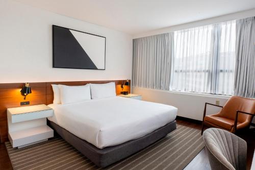 a hotel room with a bed and a chair at Eurostars St Gregory Dupont Circle Georgetown in Washington