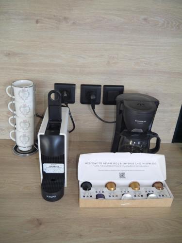 a coffee maker and a box on a table at Brisa Del Mar - Camarouche in Quartier de Lorient