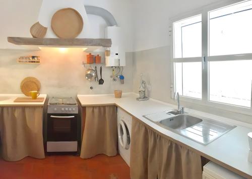 a kitchen with a sink and a stove at Country House With Private Pool in Poço do Álamo