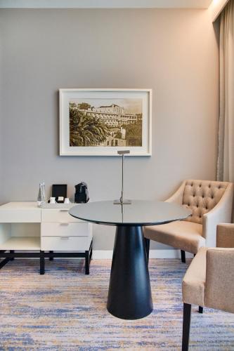 a living room with a table and a couch at InterContinental Cascais-Estoril by IHG in Estoril