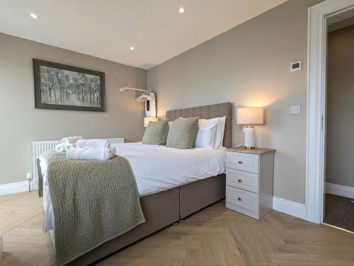 a bedroom with a large bed and a night stand at Mountain View Rooms in Newcastle
