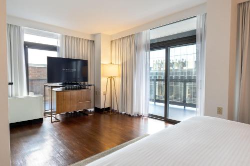 a hotel room with a bed and a flat screen tv at Eurostars St Gregory Dupont Circle Georgetown in Washington
