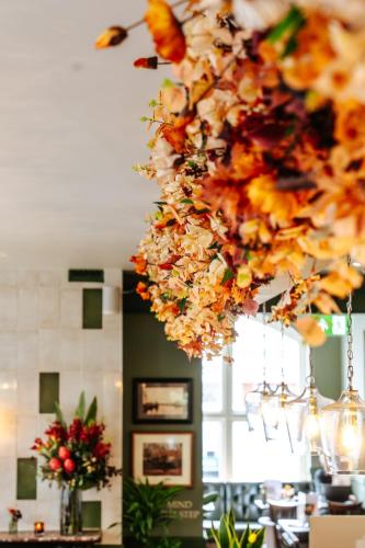 a bunch of flowers hanging from a chandelier at The Ox Pub & Rooms in Poole