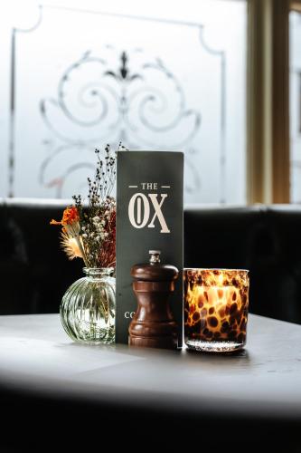 a book and a vase on a table at The Ox Pub & Rooms in Poole
