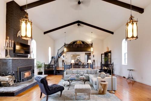 a living room with a couch and a fireplace at The Prince Edward County Church, A Unique Escape in Belleville