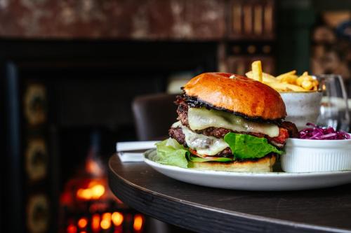 a sandwich on a plate with a side of fries at The Ox Pub & Rooms in Poole
