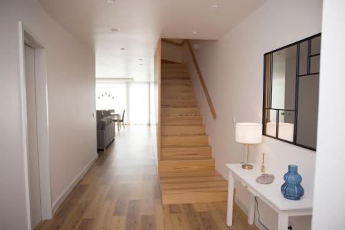 a hallway of a home with a staircase and wooden floors at Casa Dona Isabel - ocean suites in Lagoa