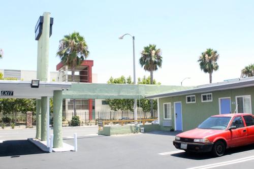 a red car parked at a gas station at Town House Motel in Lynwood